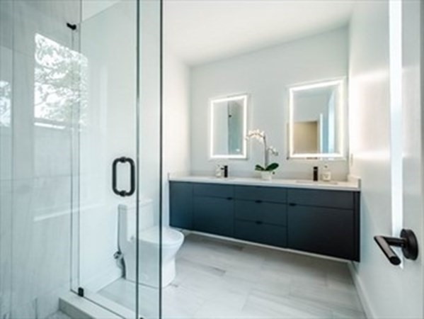 243 Condor Street, Unit 3 Boston, MA 02128 - Photo 13 of 16 a bathroom with a double vanity sink mirror and shower