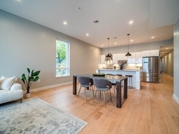 243 Condor Street, Unit 3 Boston, MA 02128 - Photo 6 of 16 a view of a dining room with furniture and wooden floor