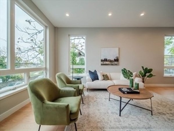 243 Condor Street, Unit 3 Boston, MA 02128 - Photo 10 of 16 a living room with furniture and a large window