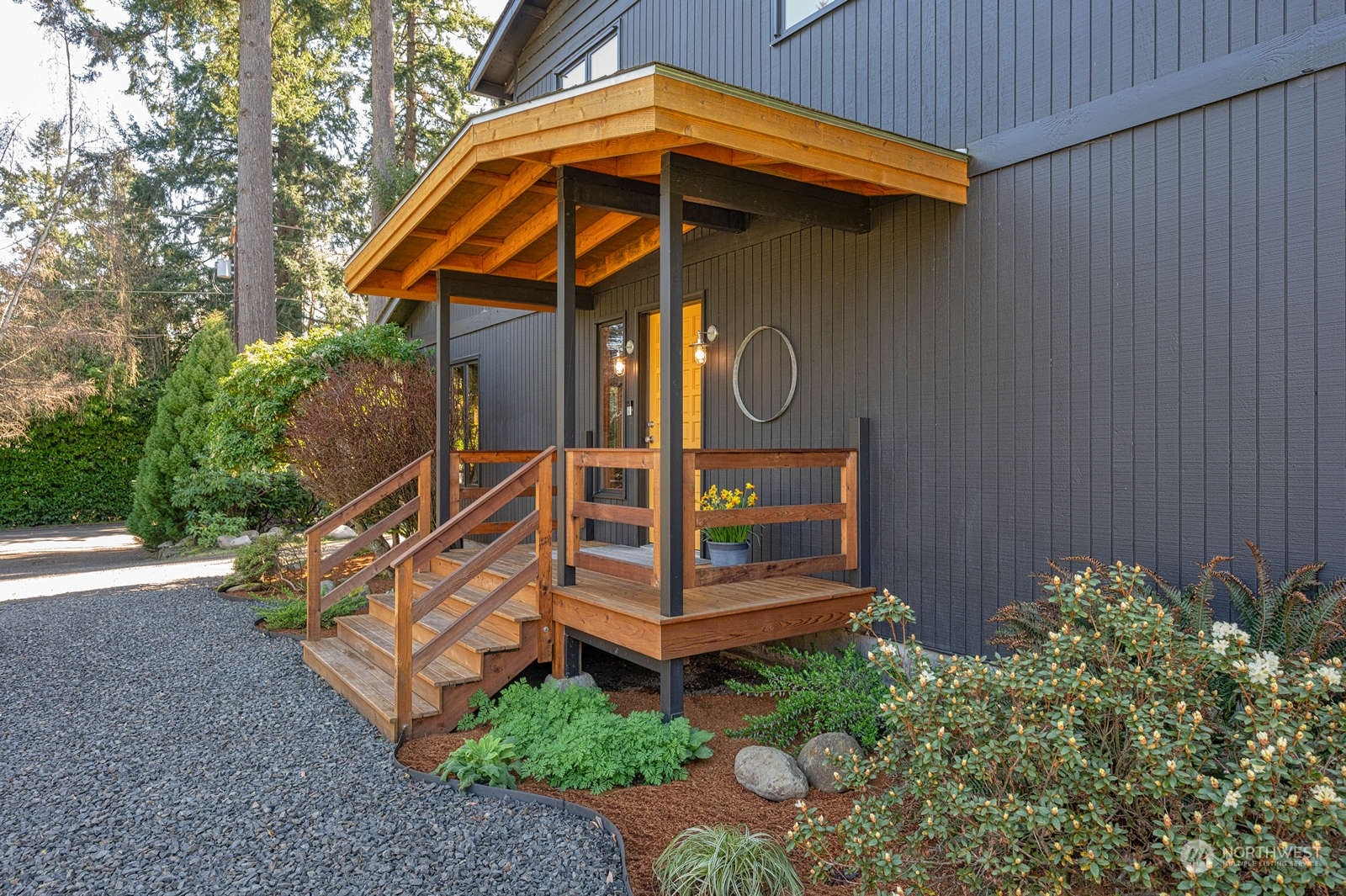 11907 103rd Avenue Southwest Vashon, WA 98070 - Photo 1 of 40 a view of a wooden house with a small yard and plants