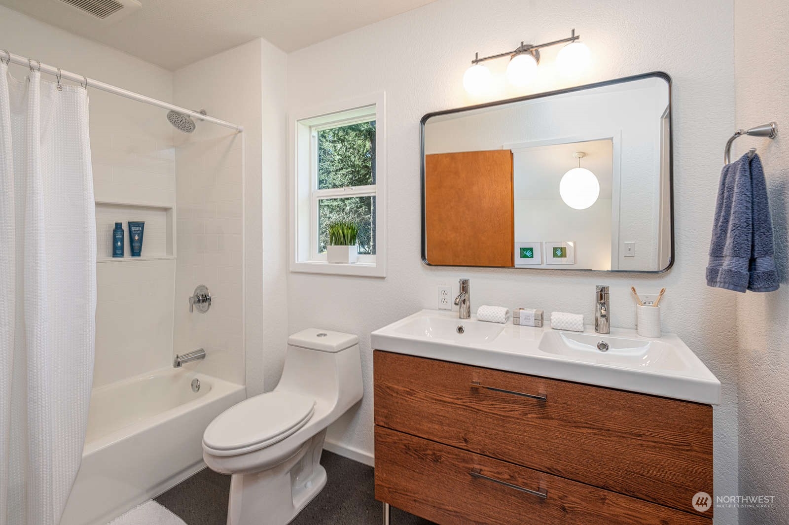 11907 103rd Avenue Southwest Vashon, WA 98070 - Photo 20 of 40 a bathroom with a toilet a sink a tub and mirror