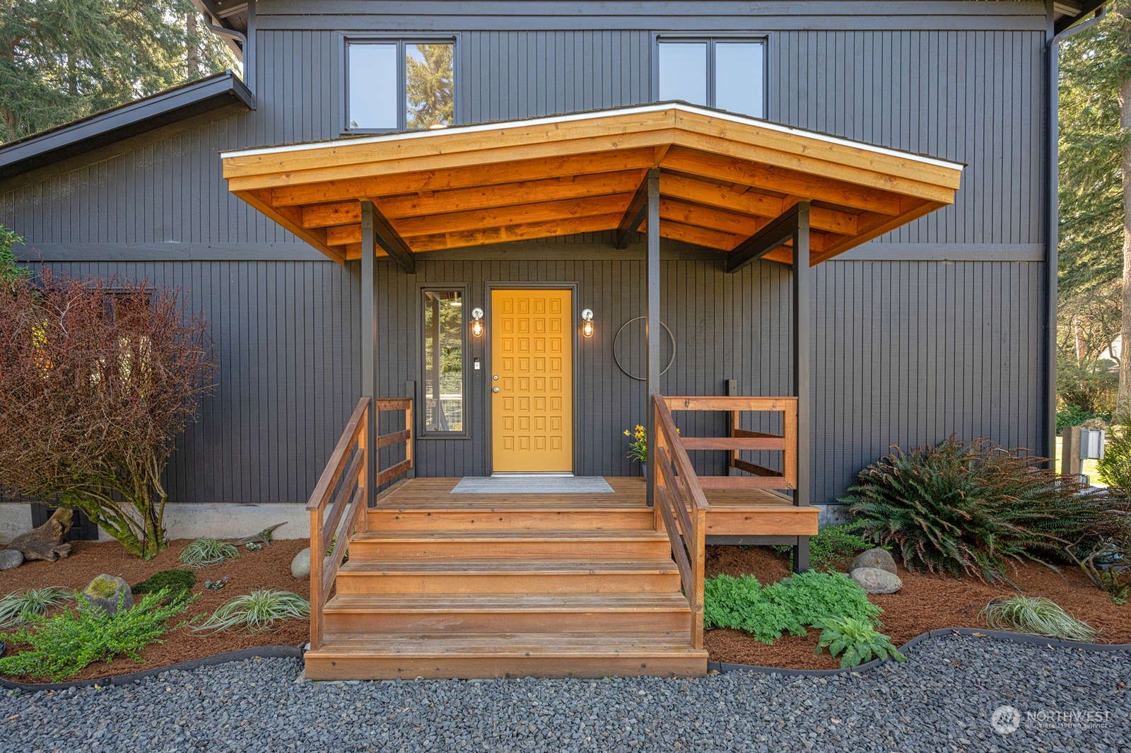 11907 103rd Avenue Southwest Vashon, WA 98070 - Photo 2 of 40 a front view of a house with garden