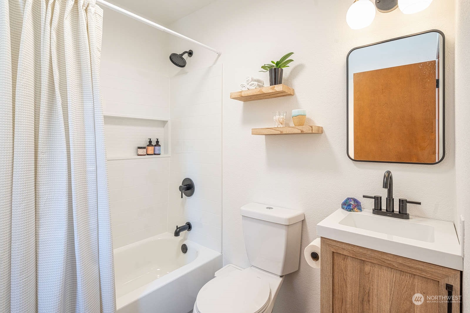 11907 103rd Avenue Southwest Vashon, WA 98070 - Photo 23 of 40 a bathroom with a sink toilet and bathtub
