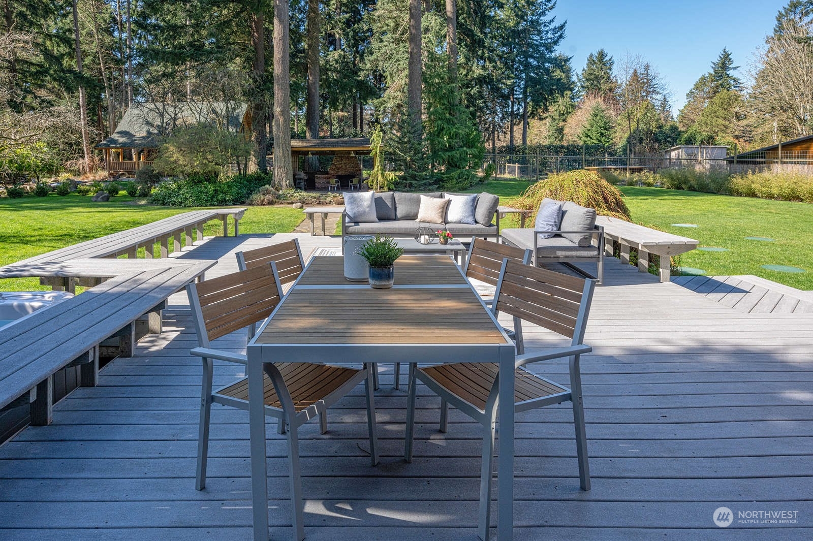 11907 103rd Avenue Southwest Vashon, WA 98070 - Photo 29 of 40 a view of deck with table and chairs couches with wooden floor and fence
