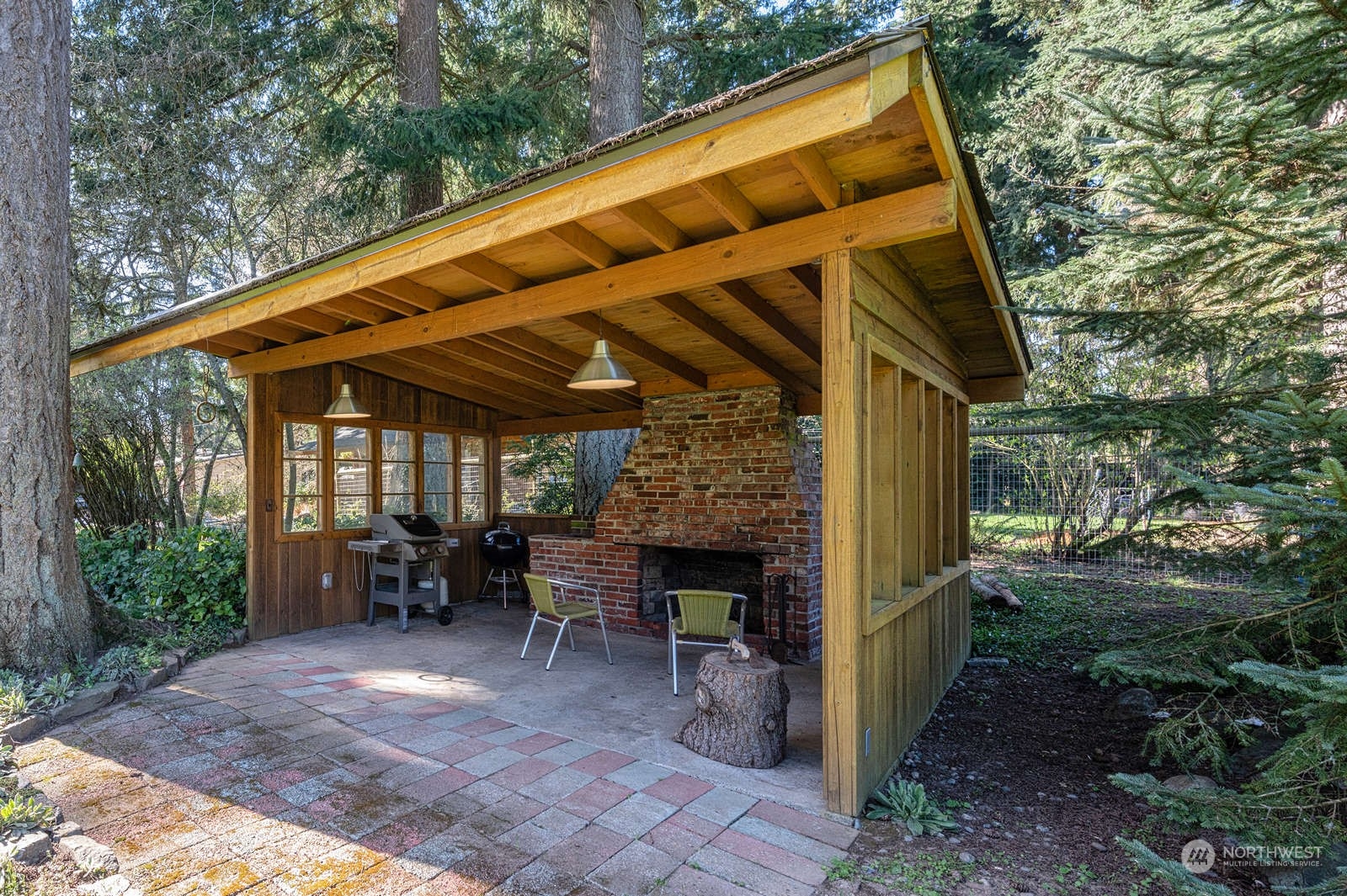 11907 103rd Avenue Southwest Vashon, WA 98070 - Photo 36 of 40 a view of a patio with table and chairs with wooden floor and fence