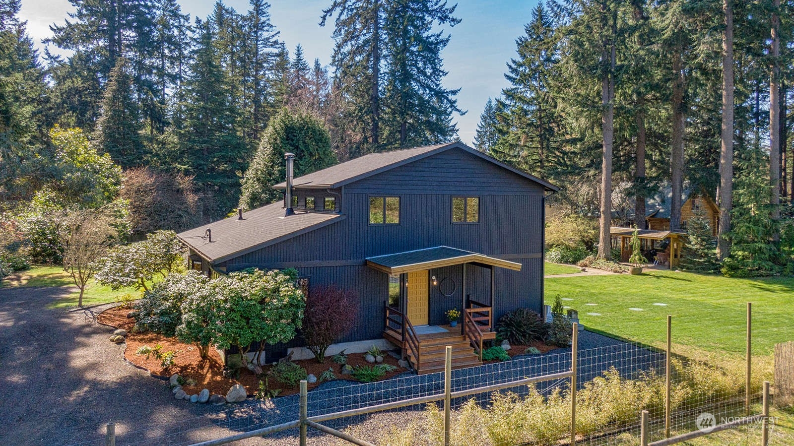 11907 103rd Avenue Southwest Vashon, WA 98070 - Photo 38 of 40 a front view of a house with garden