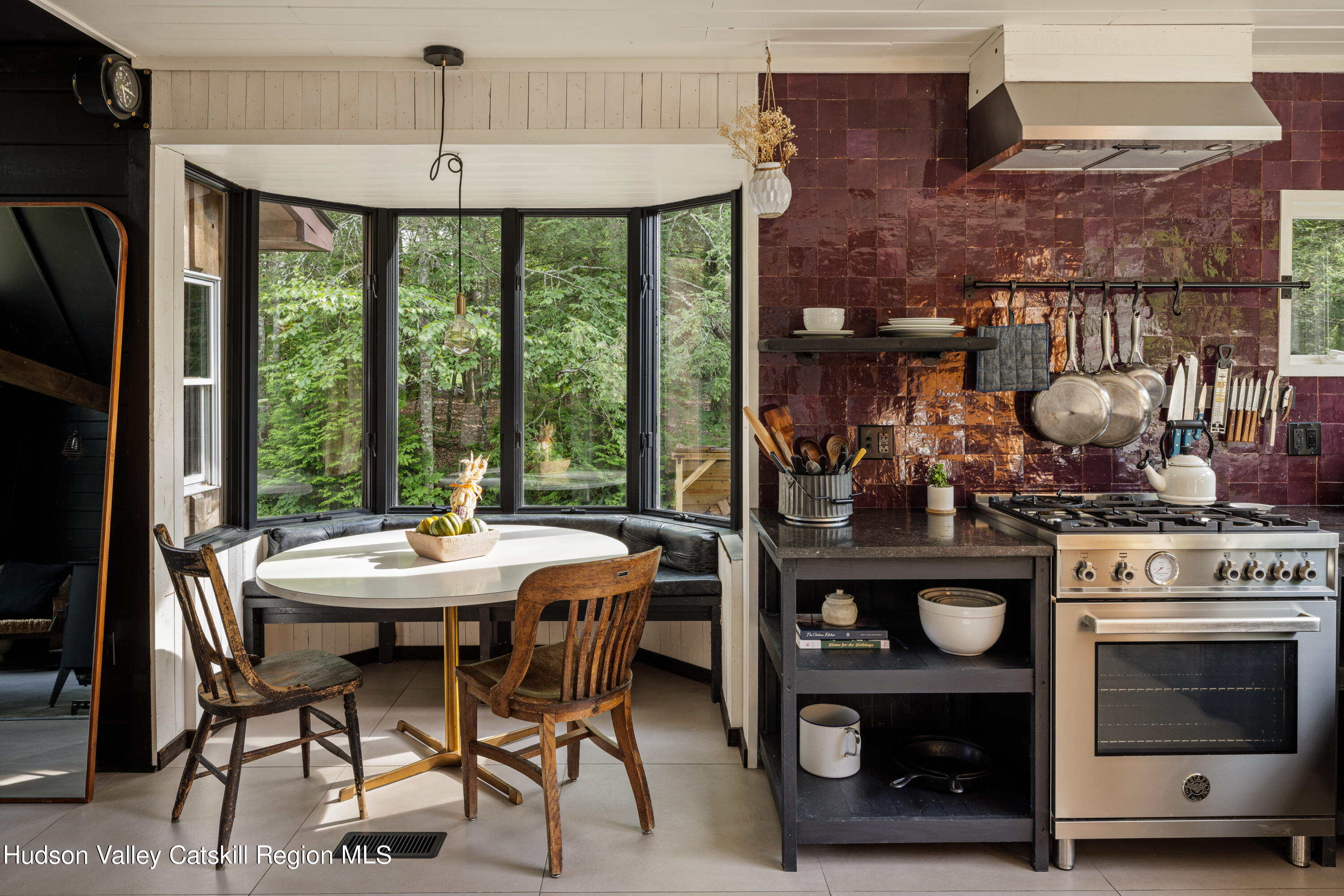 193 Cantine Road Kingston, NY 12401 - Photo 15 of 36 a kitchen with stainless steel appliances a stove a table and chairs in it