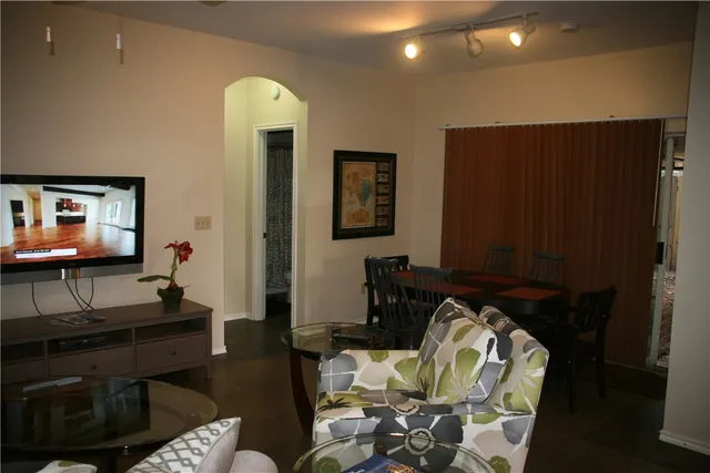 a living room with furniture and a lamp