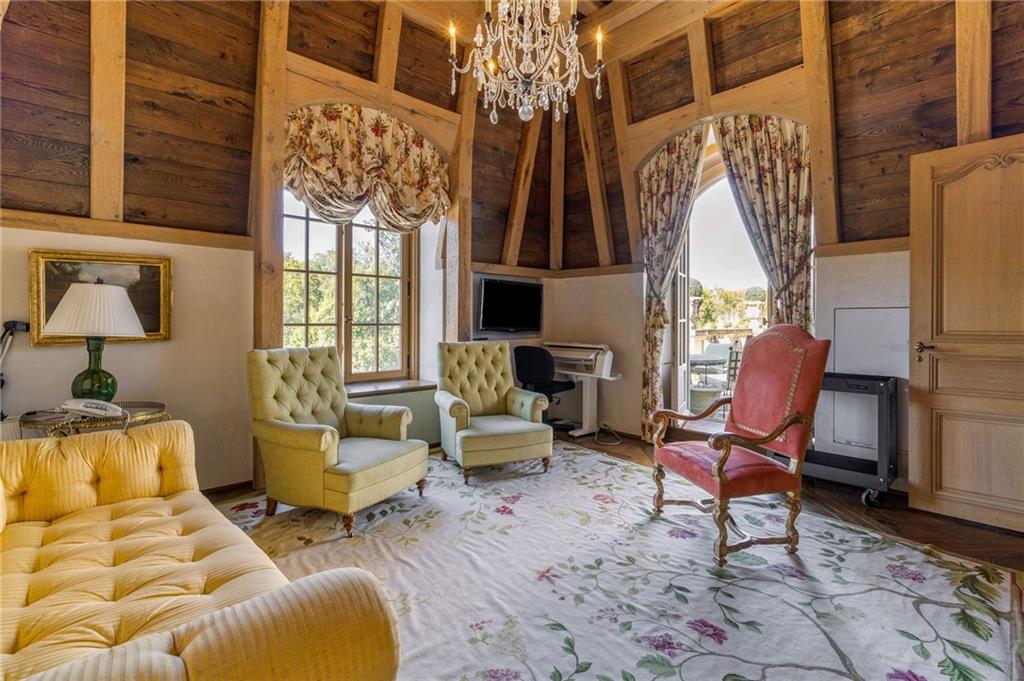 2288 Peachtree Road Northwest, Unit 6 Atlanta, GA 30309 - Photo 71 of 87 a living room with furniture a fireplace and a floor to ceiling window