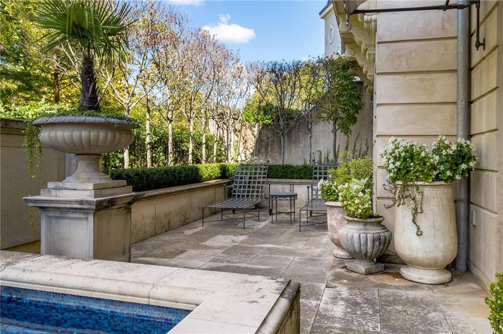 2288 Peachtree Road Northwest, Unit 6 Atlanta, GA 30309 - Photo 83 of 87 a view of a patio with table and chairs potted plants and palm trees