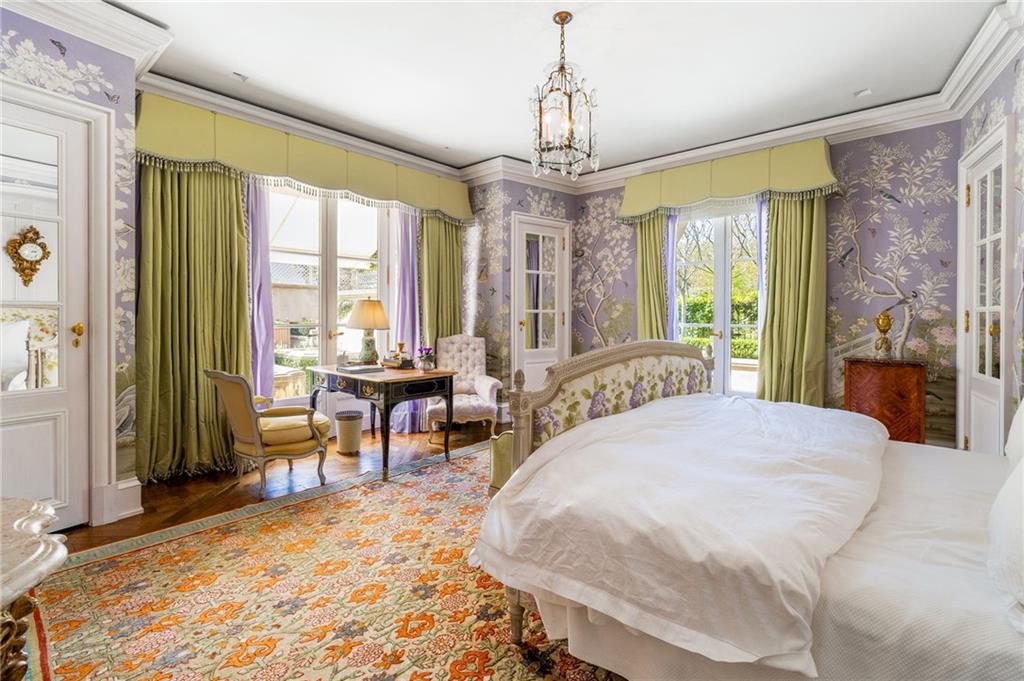 2288 Peachtree Road Northwest, Unit 6 Atlanta, GA 30309 - Photo 9 of 87 a spacious bedroom with a bed and a chandelier