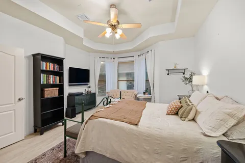 a bedroom with a bed and a flat screen tv
