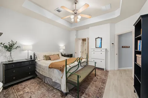 a bedroom with a bed and a chandelier