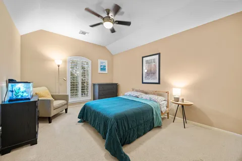a bedroom with a bed couch and window
