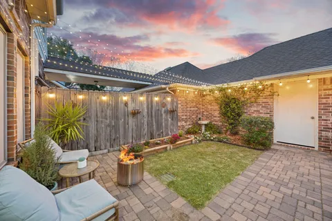 a view of a patio with couches and potted plants