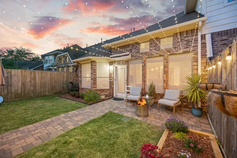 a backyard of a house with outdoor seating