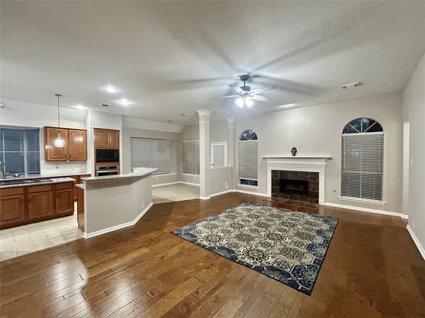 a view of open kitchen with fireplace and window