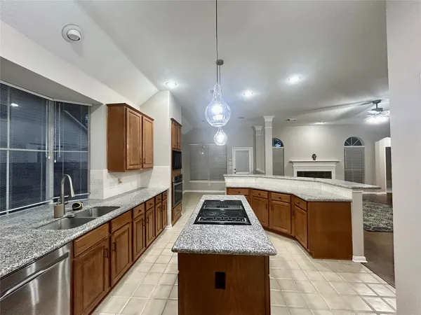 a large kitchen with kitchen island a sink counter space and stainless steel appliances