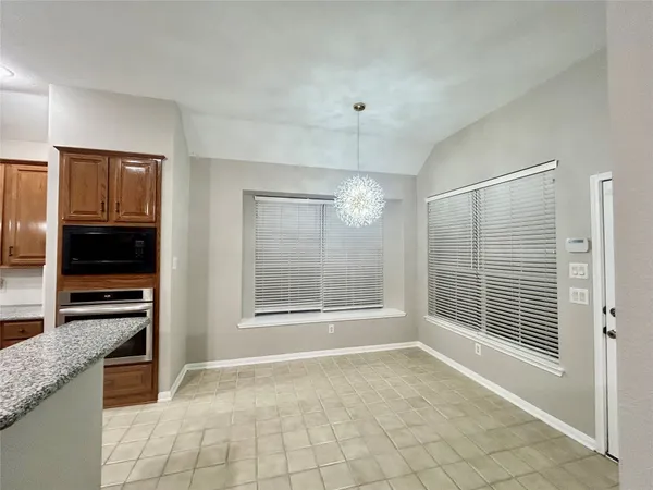 a view of an empty room with a fireplace and a window