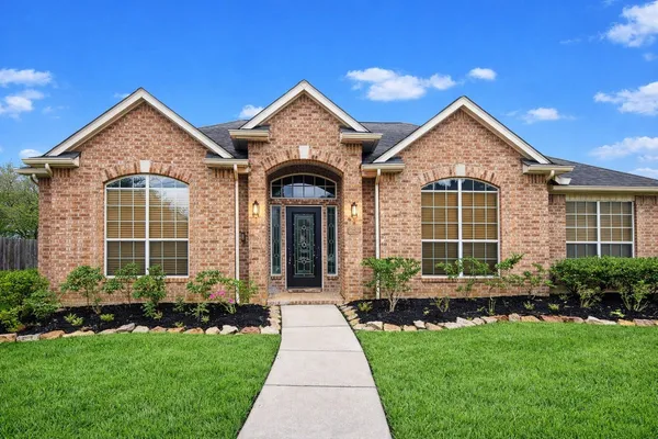 a front view of a house with a yard