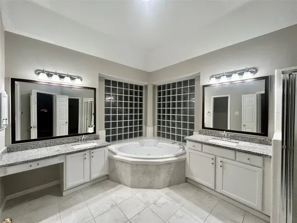 a bathroom with a bathtub sink and mirror