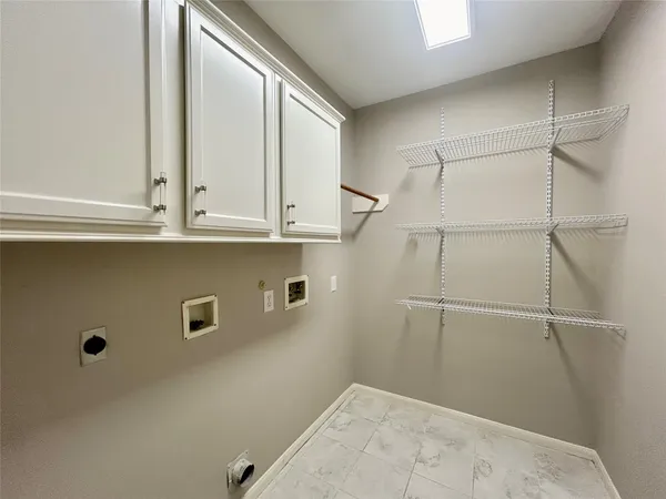 a view of a closet area with wooden floor