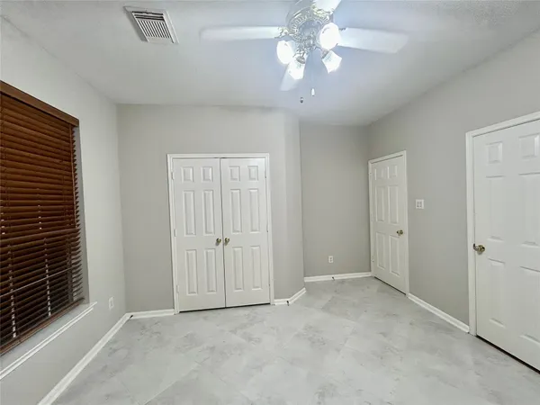 a view of an empty room with a fan