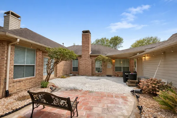 a view of a patio with a table and chairs