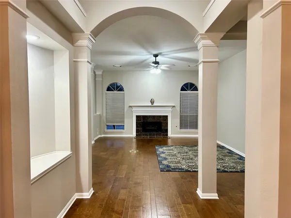 a view of a livingroom with a fireplace a chandelier and mountain view