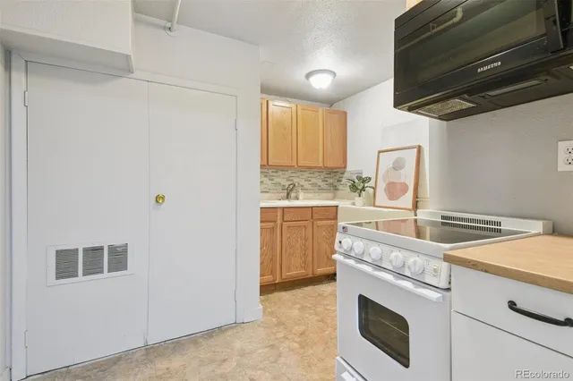 a kitchen with a stove and a microwave