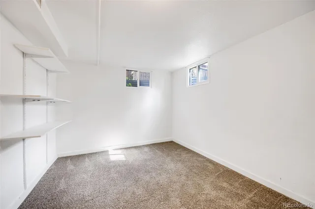 an empty room with a empty space and windows