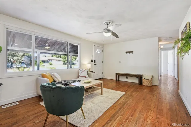 a living room with furniture and wooden floor