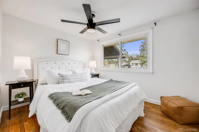 a bedroom with a large bed and a painting on the wall