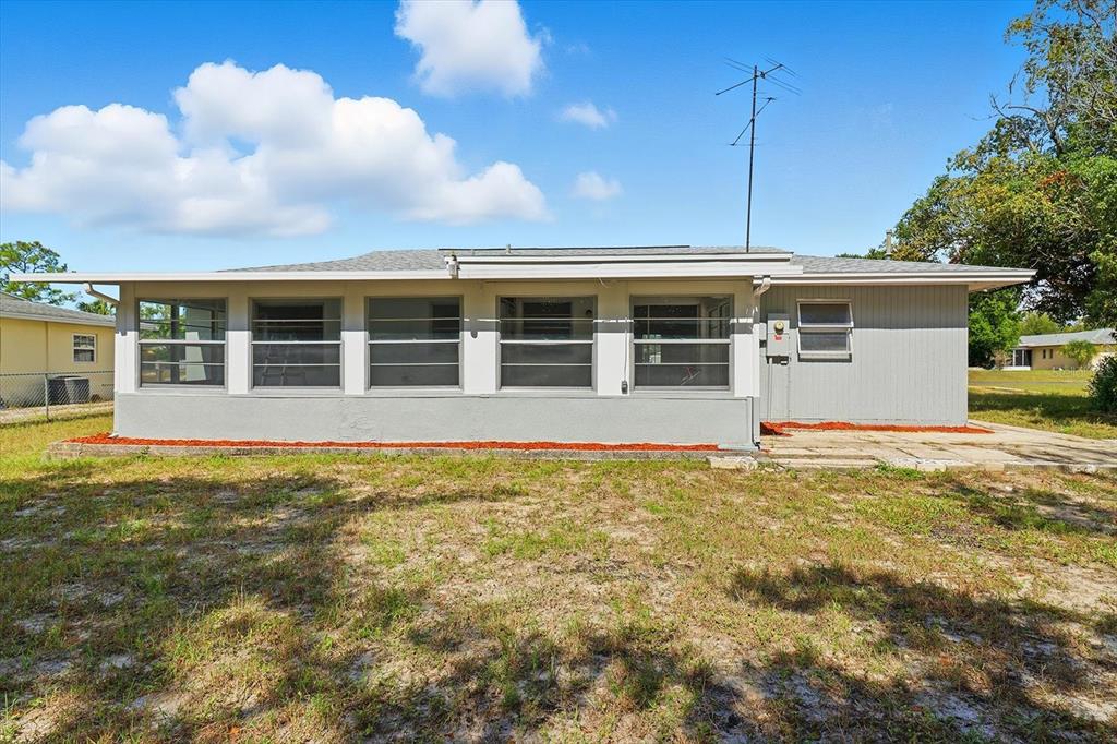 6832 Treehaven Drive Spring Hill, FL 34606 - Photo 24 of 29 a view of a house with a backyard and a tree