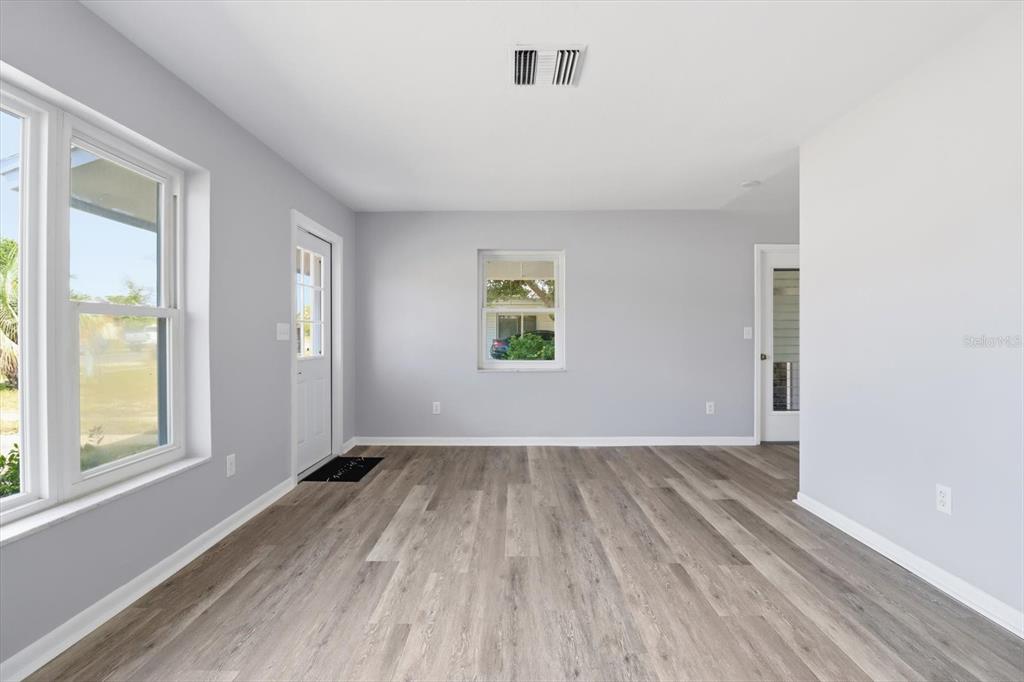 6832 Treehaven Drive Spring Hill, FL 34606 - Photo 4 of 29 an empty room with wooden floor and windows