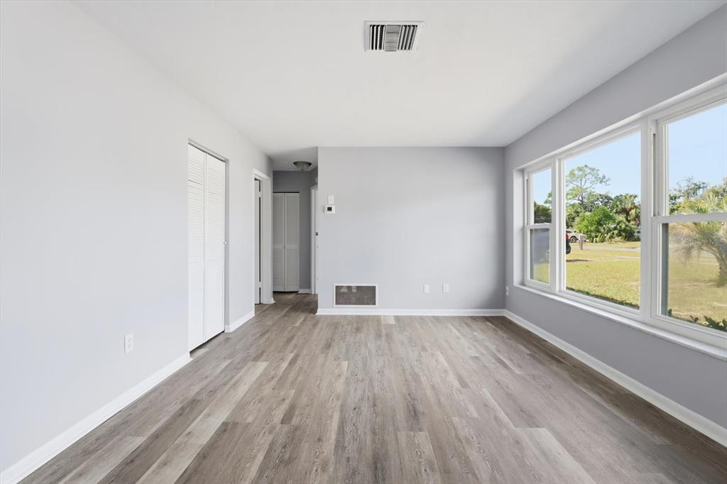6832 Treehaven Drive Spring Hill, FL 34606 - Photo 5 of 29 an empty room with wooden floor and windows