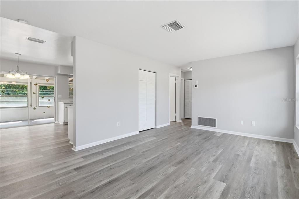 6832 Treehaven Drive Spring Hill, FL 34606 - Photo 6 of 29 a view of an empty room with wooden floor and a window