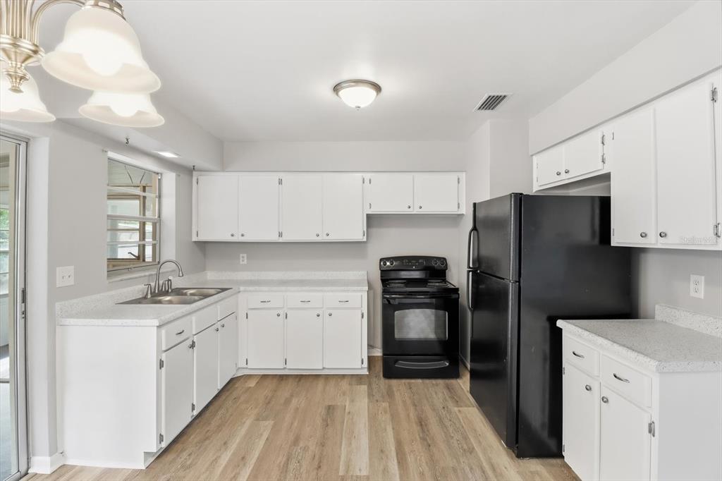 6832 Treehaven Drive Spring Hill, FL 34606 - Photo 8 of 29 a kitchen with a refrigerator stove and sink