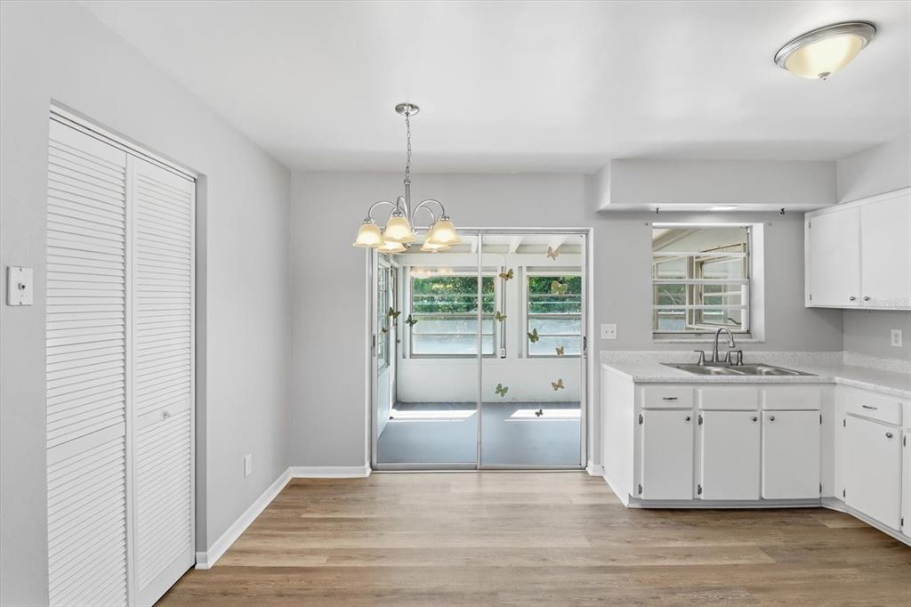 6832 Treehaven Drive Spring Hill, FL 34606 - Photo 9 of 29 a large white kitchen with a sink and cabinets
