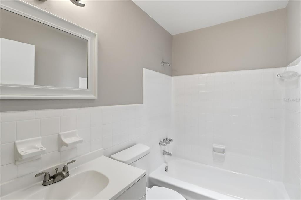 6832 Treehaven Drive Spring Hill, FL 34606 - Photo 10 of 29 a bathroom with a sink and a mirror