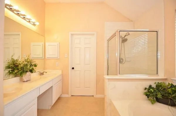 a bathroom with a tub shower and a sink