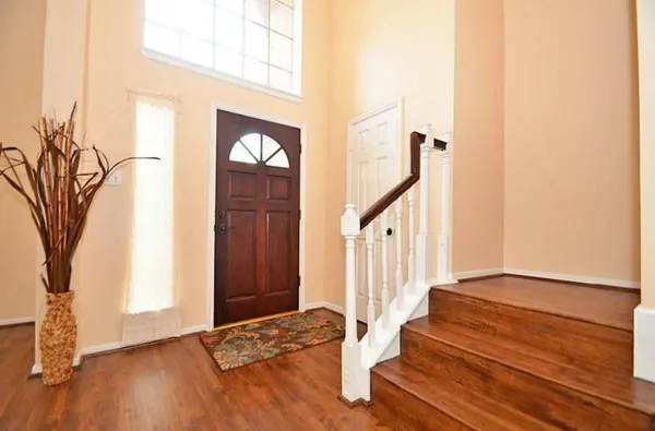 a view of an entryway with wooden floor and a window