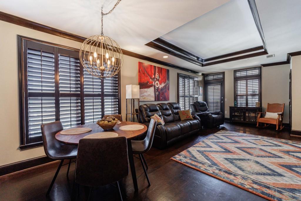 a living room with furniture and a chandelier