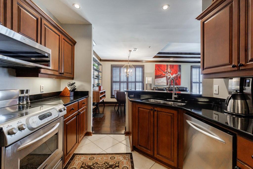 3334 Peachtree Road Northeast, Unit 1506 Atlanta, GA 30326 - Photo 11 of 51 a kitchen with stainless steel appliances a stove sink and cabinets