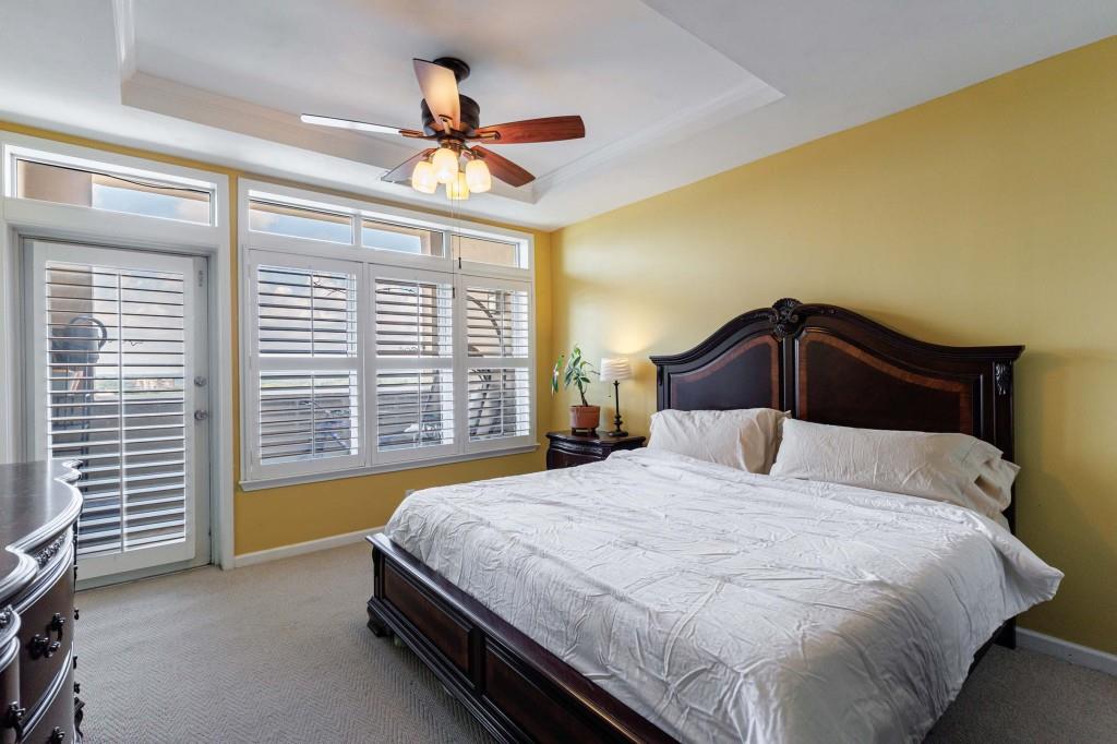 3334 Peachtree Road Northeast, Unit 1506 Atlanta, GA 30326 - Photo 12 of 51 a bedroom with a bed and a chandelier