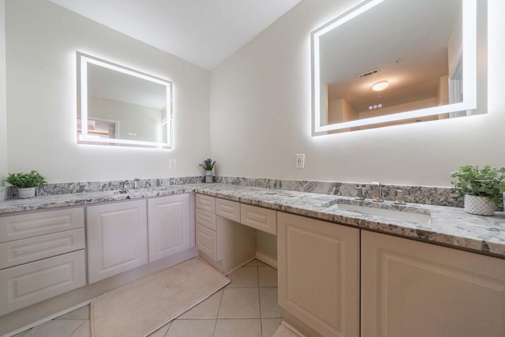 3334 Peachtree Road Northeast, Unit 1506 Atlanta, GA 30326 - Photo 16 of 51 a bathroom with a granite countertop sink and a mirror