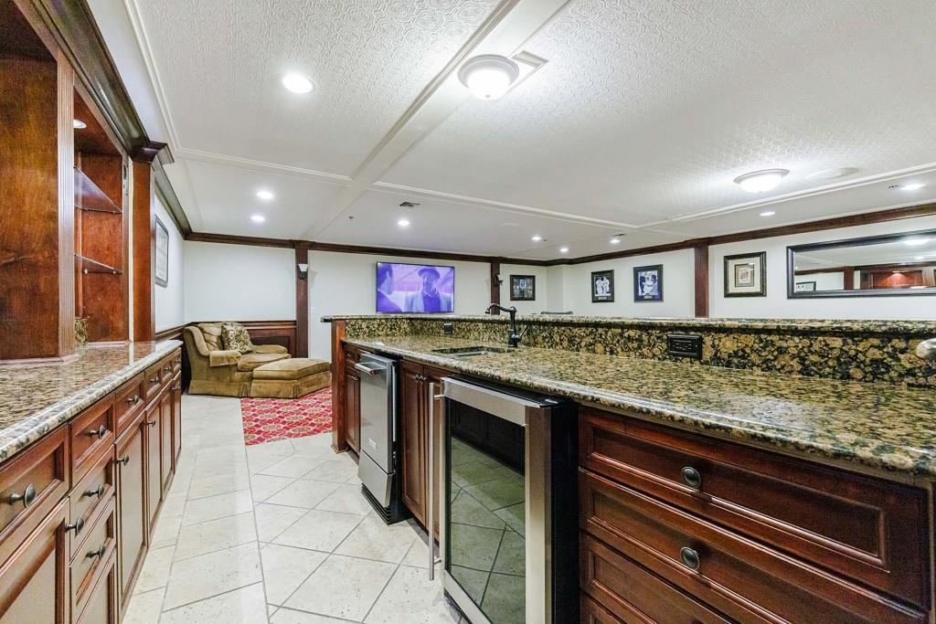 3334 Peachtree Road Northeast, Unit 1506 Atlanta, GA 30326 - Photo 41 of 51 a large kitchen with stainless steel appliances granite countertop a lot of counter space and a sink