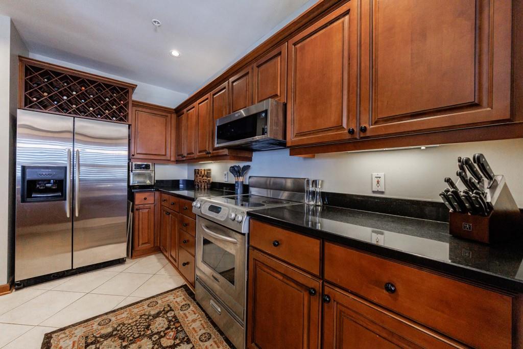3334 Peachtree Road Northeast, Unit 1506 Atlanta, GA 30326 - Photo 8 of 51 a kitchen with stainless steel appliances granite countertop a refrigerator sink and microwave