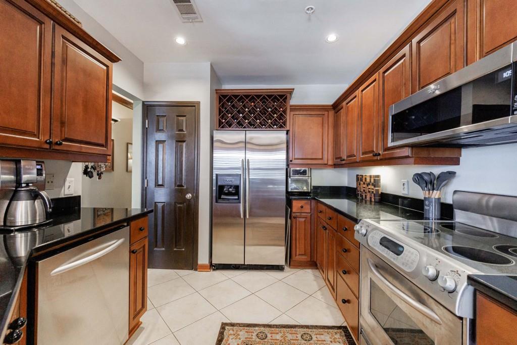 3334 Peachtree Road Northeast, Unit 1506 Atlanta, GA 30326 - Photo 9 of 51 a kitchen with stainless steel appliances granite countertop a stove a refrigerator and a sink