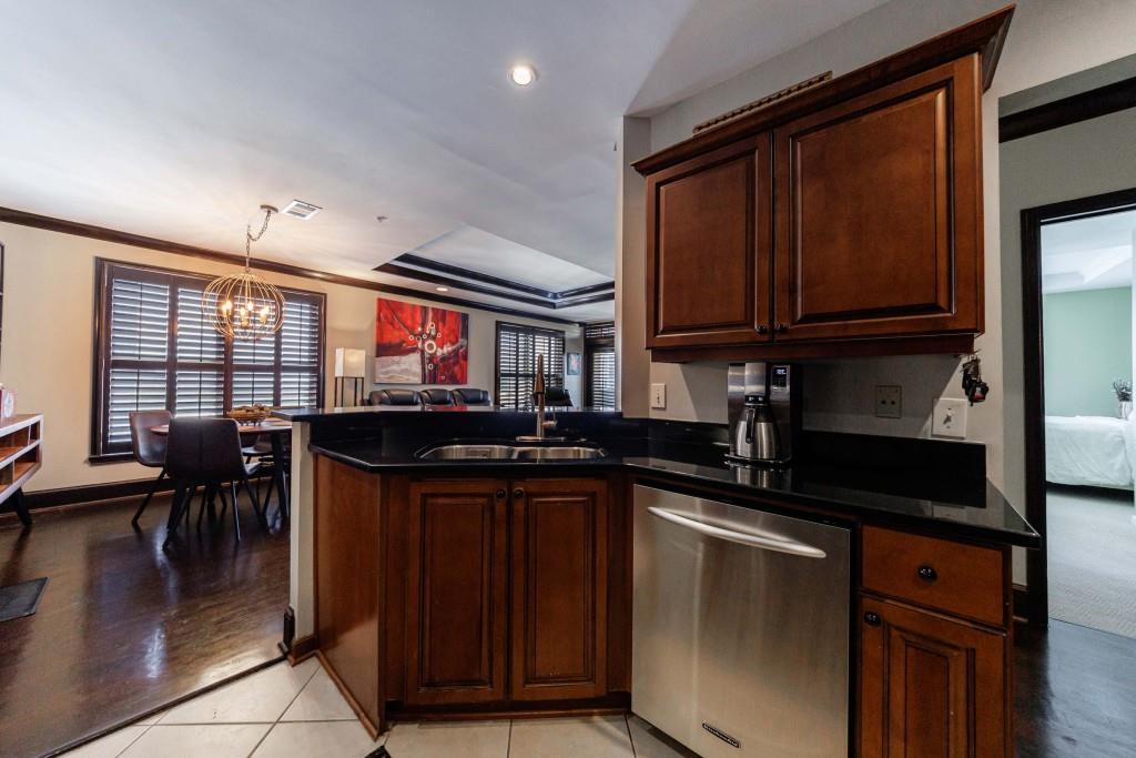 3334 Peachtree Road Northeast, Unit 1506 Atlanta, GA 30326 - Photo 10 of 51 a kitchen with a sink and wooden cabinets